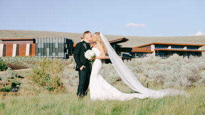 Gorgeous Wedding at Promontory Club, Park City Utah in front of clubhouse. Long train on grass