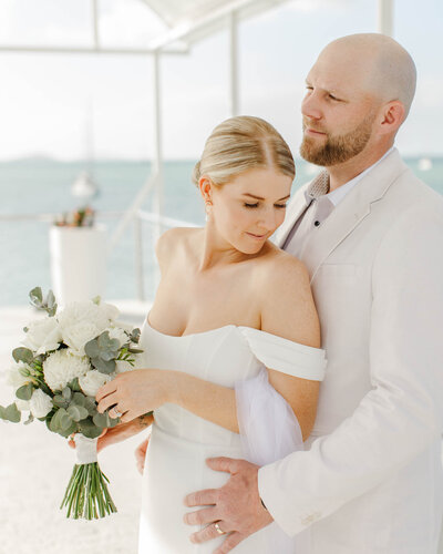 newlyweds posing during their sunset wedding portraits at mackay wedding.