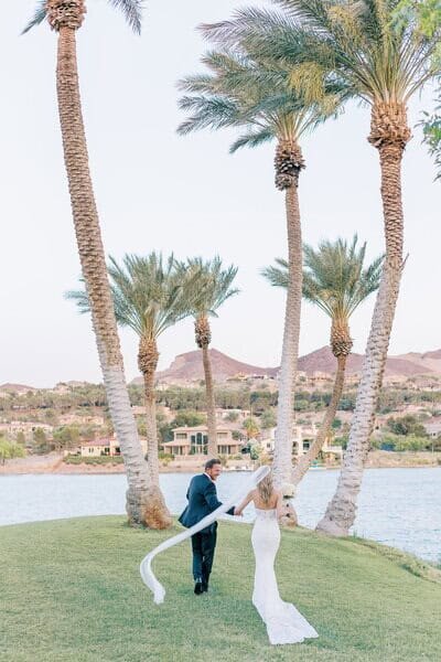 Bride and Groom walking holding hands at Reflection Bay Lake Las Vegas