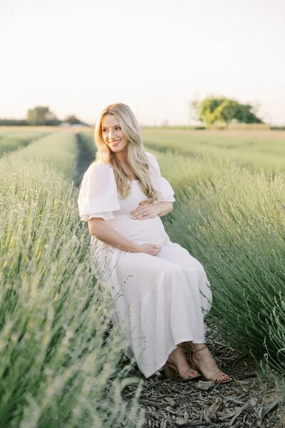 Engaged couple poses together on a flower field in Fresno