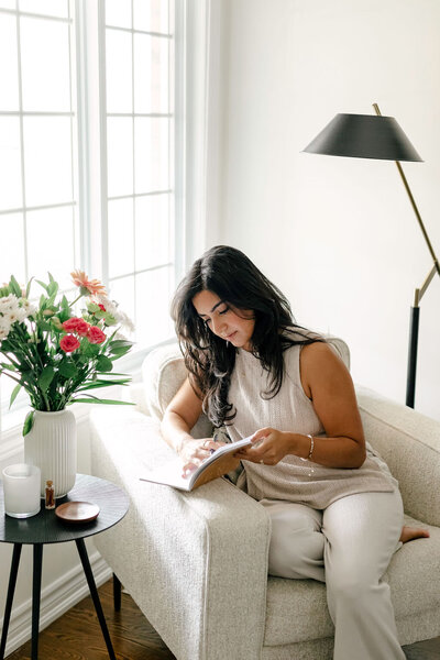 Woman Journaling by the Window