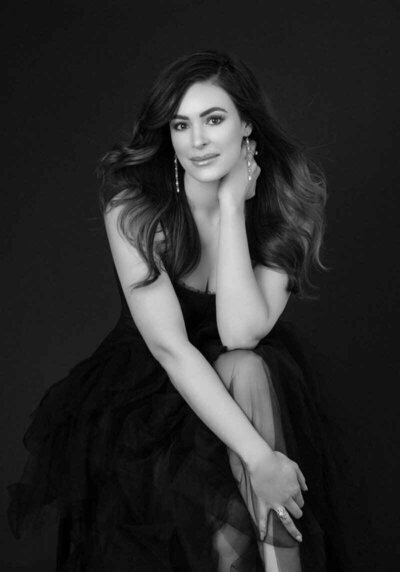 Elegant black and white portrait of a woman in a tulle gown.