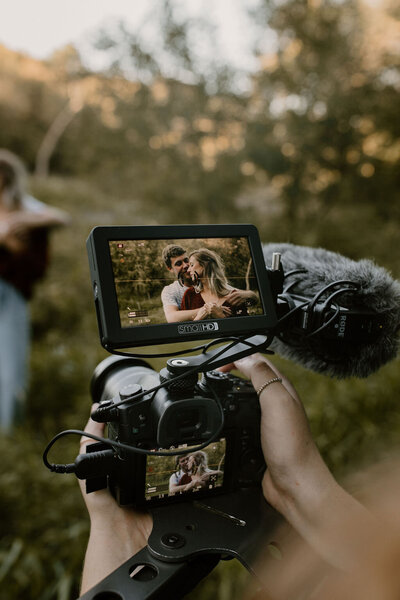 photo showing the back of video camera during an engagement videography shoot