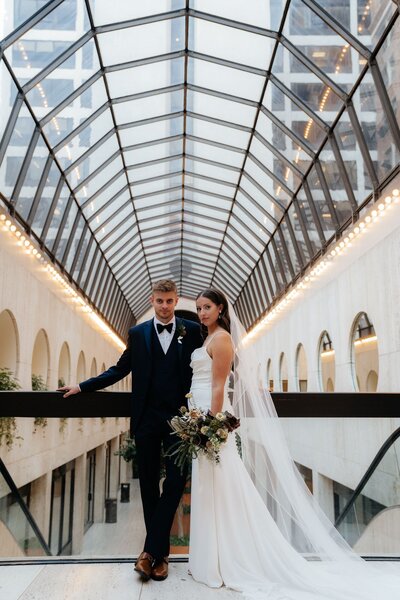 Bride and groom under skylight