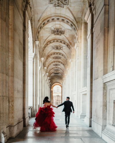 asian couple running at louvre in paris