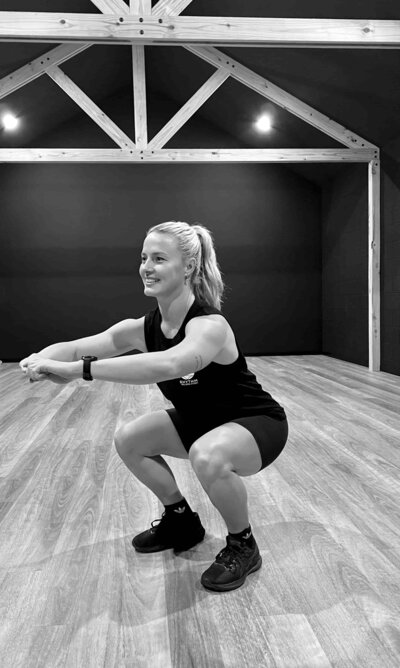 female Exercise physiologist squatting