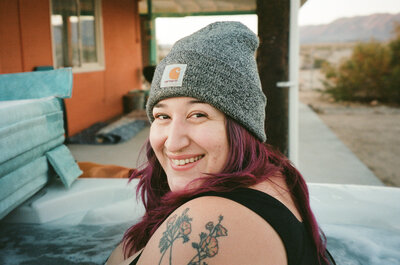 A person in a beanie smiling.