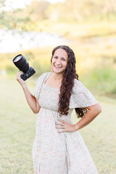 Sarasota Florida Wedding Photographer Deanna Grace smiling and holding camera