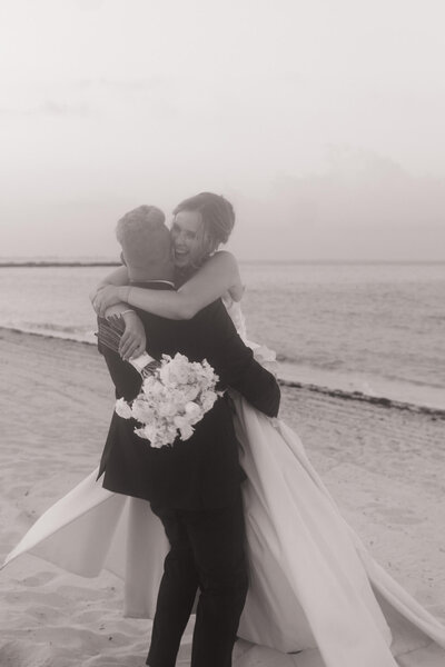 bride and groom sharing a loving embrace on the beach together in mexico 