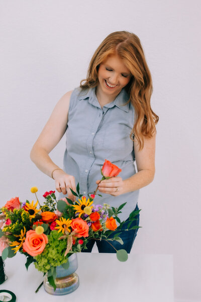 Fort Worth's luxury wedding florist making a colorful floral arrangement.