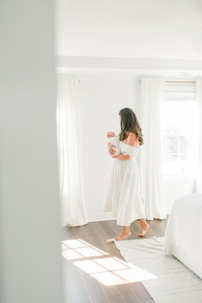 Jessica Jeremiah Photography mother holding baby in white studio