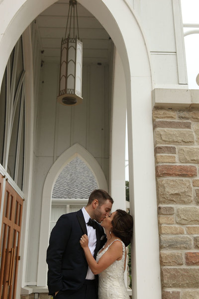Couple kissing at church on their wedding day