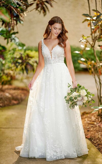 RELAXED A-LINE WEDDING DRESS WITH LACE Casual princess brides, this one is for you. This soft A-line style has a little bit of everything, while staying subtle enough to let you do the shining. The V-neckline features a skinny plunge for coverage, while wider lace straps offer support and comfort. Beadwork is concentrated throughout the neckline to highlight the upper body just so, while a sequin layer is added to the flowing skirt to add a hint of shine and dimension with your every move. Organically placed laces are featured throughout the skirt to enhance the flowing movement of this gown, while an open V-back features subtle organic finishing for an added natural touch.