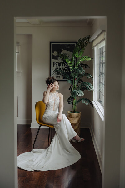 Bride adjusting hair at Finger Lakes wedding