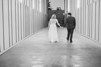 bride and groom walking black and white image