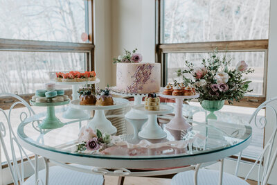 Beautiful wedding cake table inspiration; feminine pink, purple, and mint decor with handcrafted elegant pastries and desserts by Lemonberry Pastries in Calgary, Alberta.