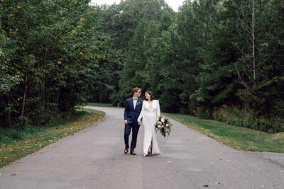 Bride and groom walking together, laughing and sharing a joyful moment during their Richmond wedding portraits.