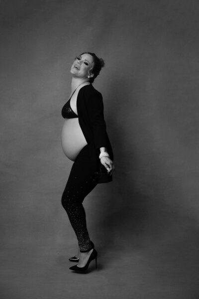 Woman wearing a black onesuit piece and showing her butt