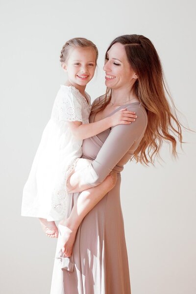 Woman holding daughter to show family photos in San Francisco