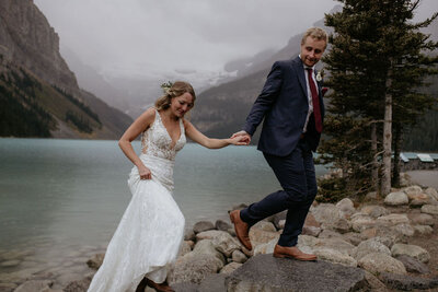 Classic wedding portrait of couple holding hands in mountains, captured by Lewis and Company, timeless and artful wedding photographer and videographer in Calgary, Alberta. Featured on the Bronte Bride Vendor Guide.