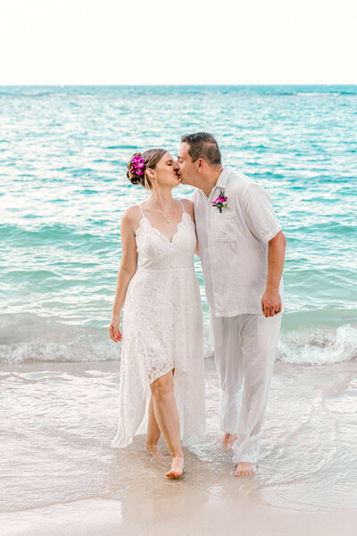 kissing bride and groom in the water