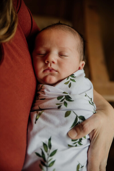 newborn in a white wrap