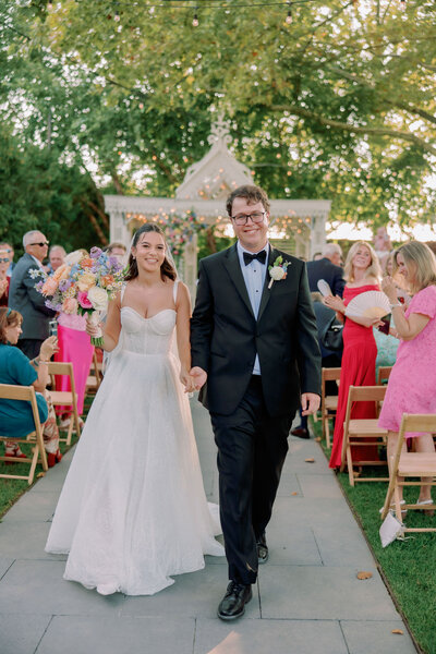 A newlywed couple walks down the aisle at a Terrain Glen Mills wedding.