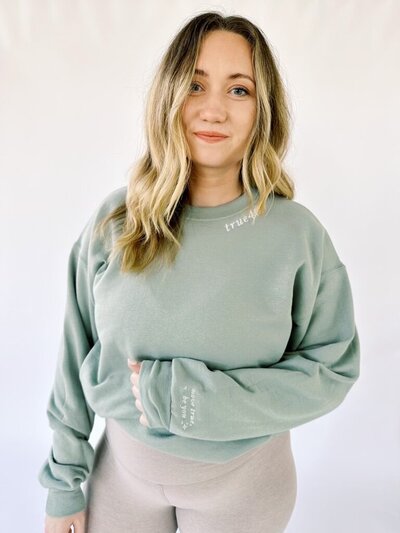 Woman wearing a green True40 embroidered sweatshirt