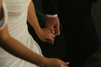 close up photo of bride an grooms hands