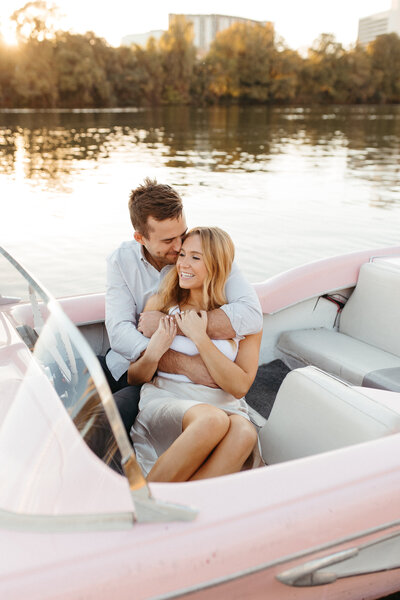 engaged couple on lady bird lake boat at sunset
