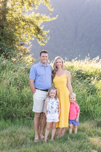 stylish family of four in a kelowna field at sunset
