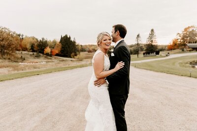 Bride and groom outdoors at rustic barn wedding venue