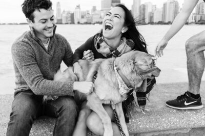 Bride and Groom sitting on North Pier with their dog laughing