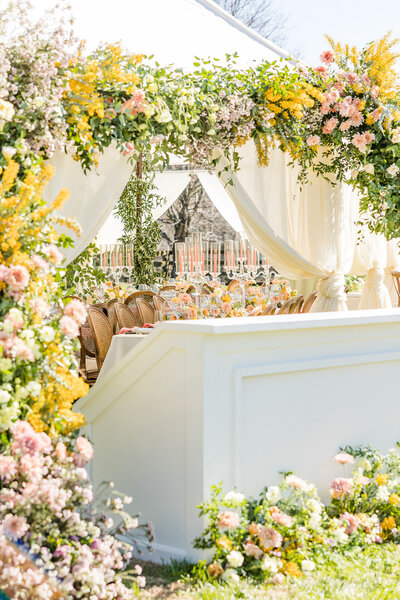 White tent wedding with yellow, pink and peach florals in Georgia.  Photographed by Meredith Mutza LLC in Milwaukee, Wisconsin.