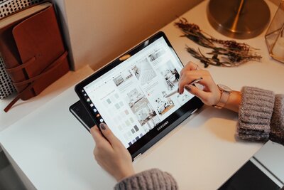 hands of a woman working on an ipad