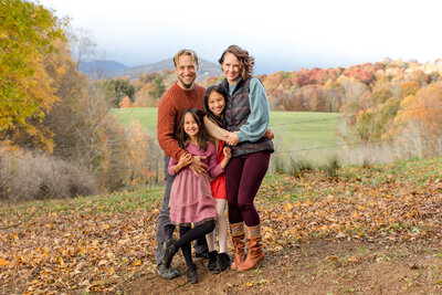 Family photo in Boone, NC of a family of four in the blue ridge mountains during a fall family photo session.