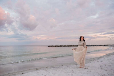 woman gets maternity photos taken on St. Pete Beach