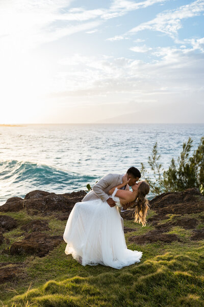 bride and groom kissing on beach