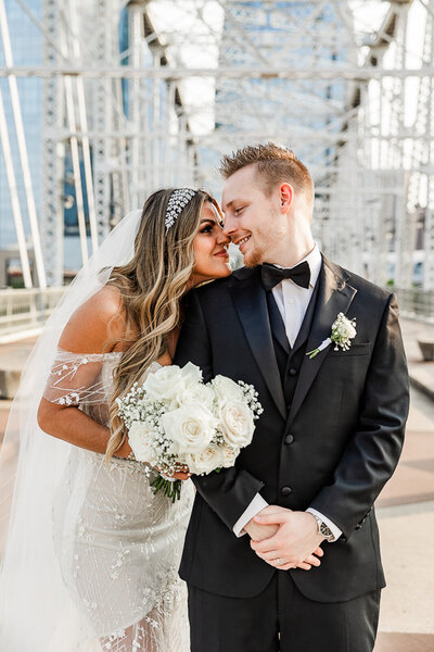 Bride gazing at her groom as he smiles at the camera