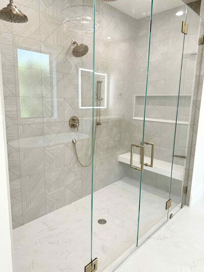 A Frisco bathroom renovation design featuring elegant and unique gold accents, creating a luxurious and sophisticated space.