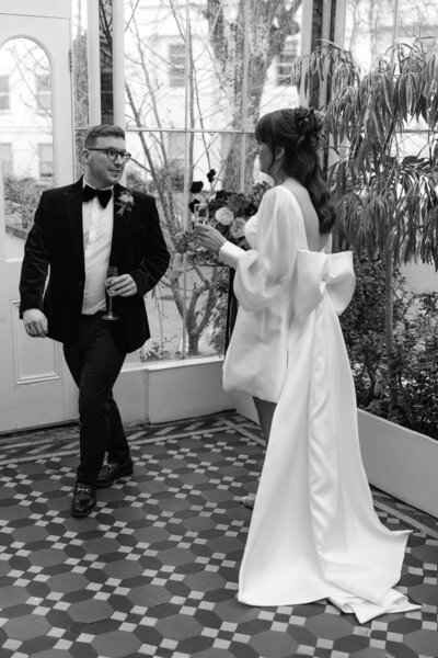 Wedding photographer captures couple taking a stroll hand in hand at their french chateau wedding.