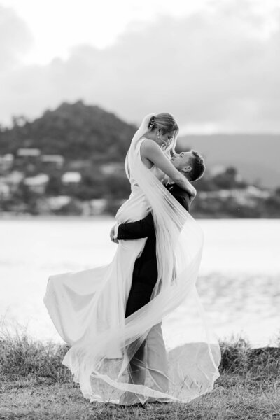 Bride & groom embracing during sunset portraits at their Mackay wedding.