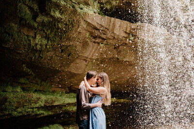 couple captured under a waterfall by birmingham alabama wedding photographer