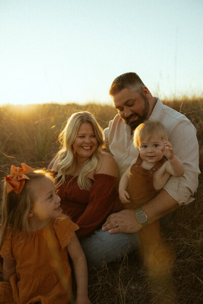 30a family sitting in dunes