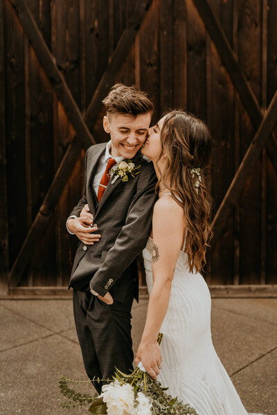 Couple kissing and holding each other while at their engagement session