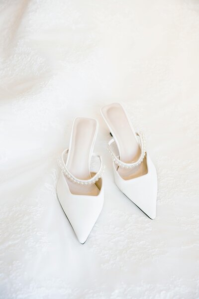 Elegant wedding shoes adorned with pearls, showcasing a delicate and sophisticated detail for the bride’s special day in Columbus, OH.