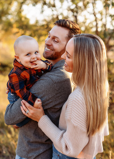 Family cuddling their newborn during a lifestyle photography session in Denver