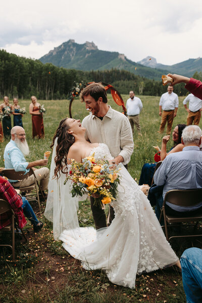 Couple shares a kiss after their mountaintop elopement in Ouray, Colorado.