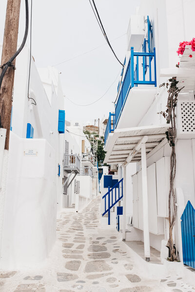 white cobblestones, white buildings and blue accented doors