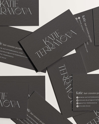 Sleek black business cards for Katie Terranova, featuring modern minimalist typography and a sophisticated design